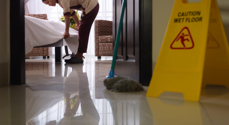 Maid at work and cleaning in luxury hotel room Asian maid tidying up bed and cleaning luxury hotel room